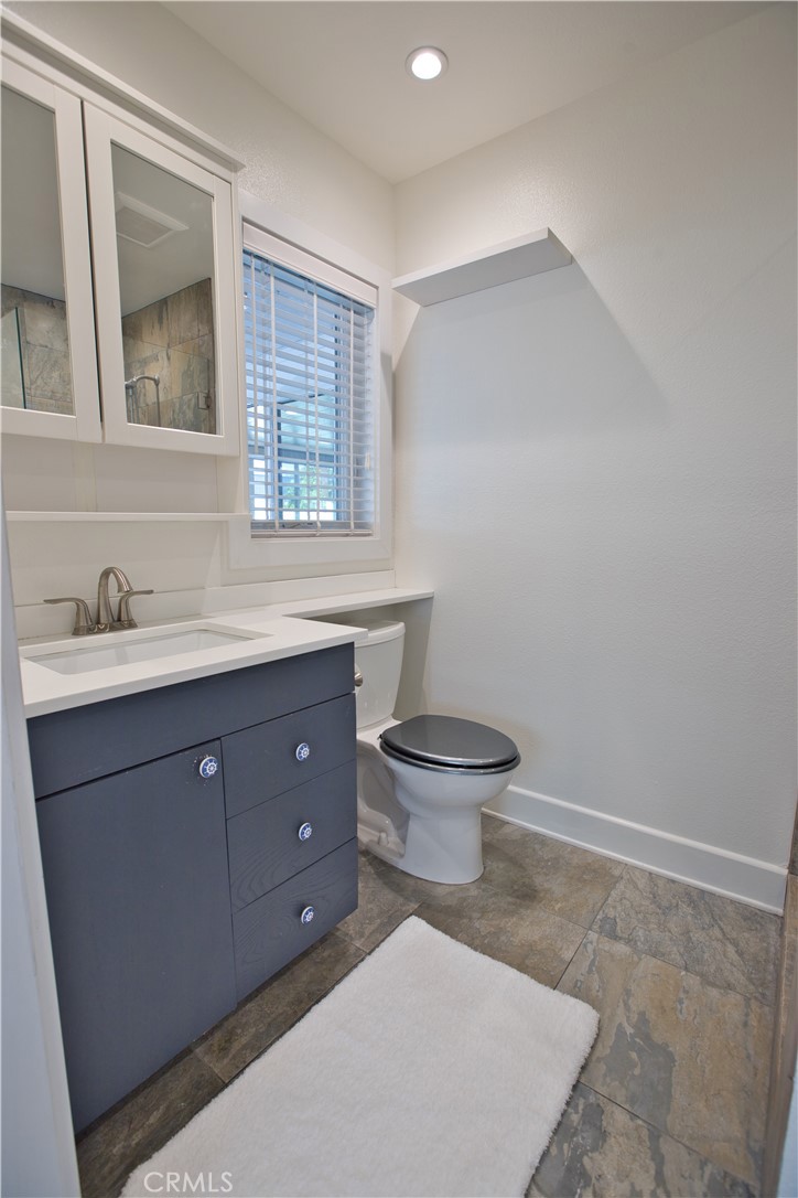 6091 Dundee Drive Huntington Beach, CA 92647 - Photo 26 of 55 a bathroom with a toilet sink and mirror