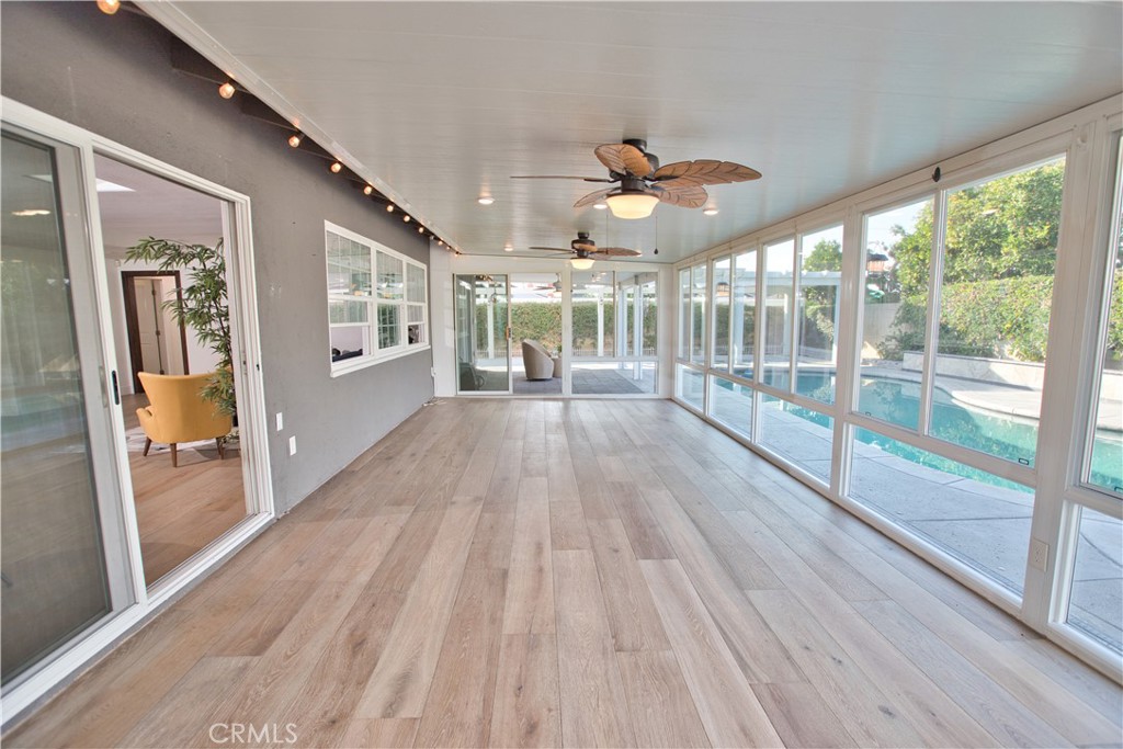 6091 Dundee Drive Huntington Beach, CA 92647 - Photo 45 of 55 a view of empty room with wooden floor and fan