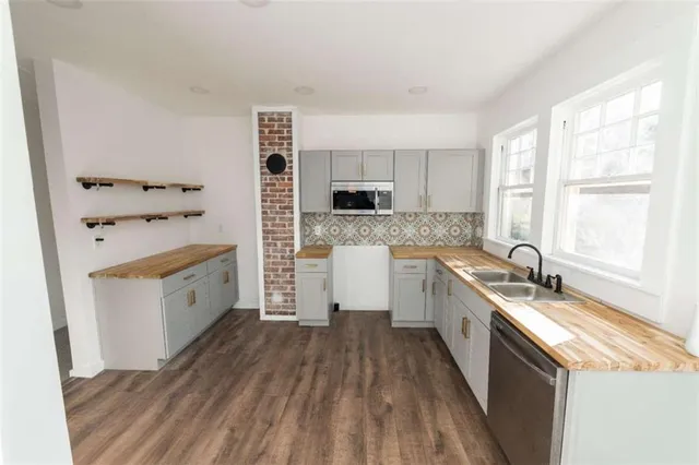 a kitchen with a stove a sink and a microwave