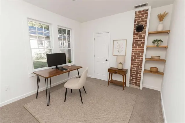 a view of a livingroom with furniture and a window