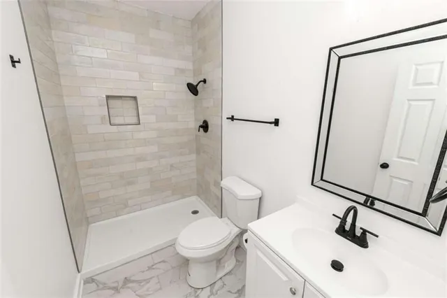 a bathroom with a sink toilet and shower