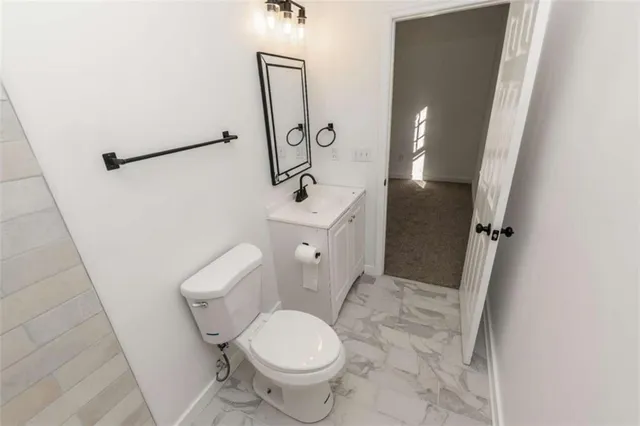 a white toilet sitting next to a bathroom sink