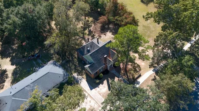 an aerial view of house with yard and outdoor seating