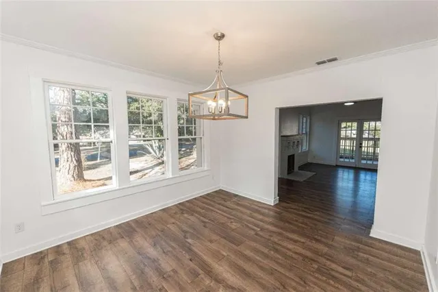 a view of a room window and wooden floor