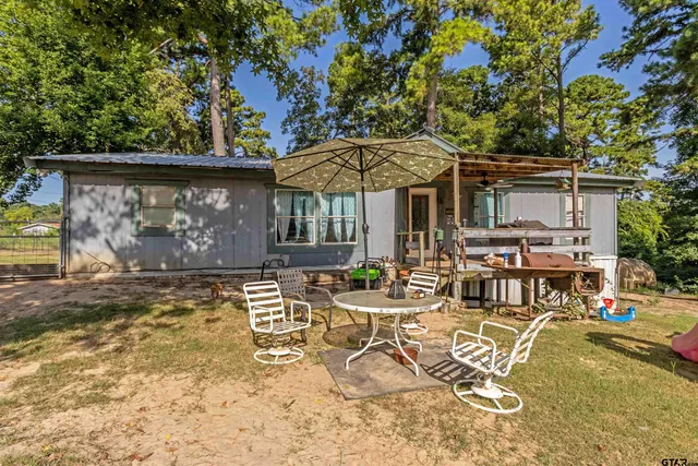 an outdoor space with furniture and umbrella