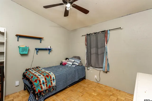 a bedroom with a bed and a dresser