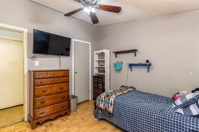 a bedroom with a bed and a flat tv screen