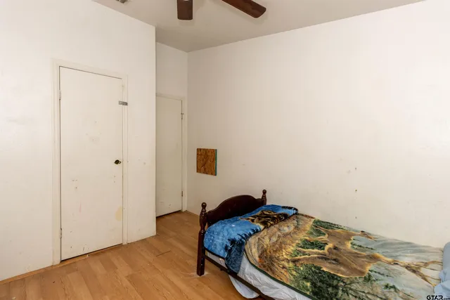 a bedroom with a bed and a wall painting