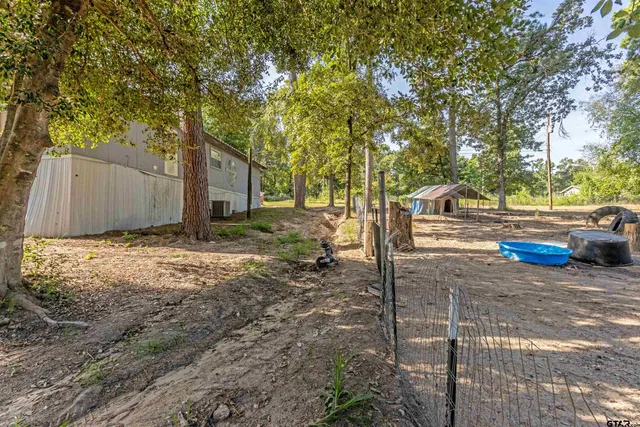 a backyard of a house with trampoline