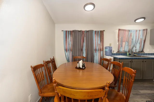 a dining room with furniture and wooden floor