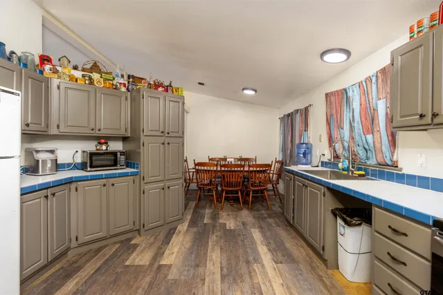 a kitchen with appliances a sink and cabinets