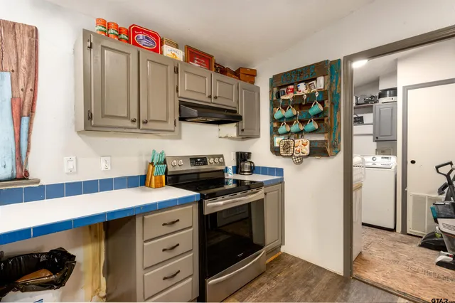 a kitchen with stainless steel appliances a stove microwave and refrigerator