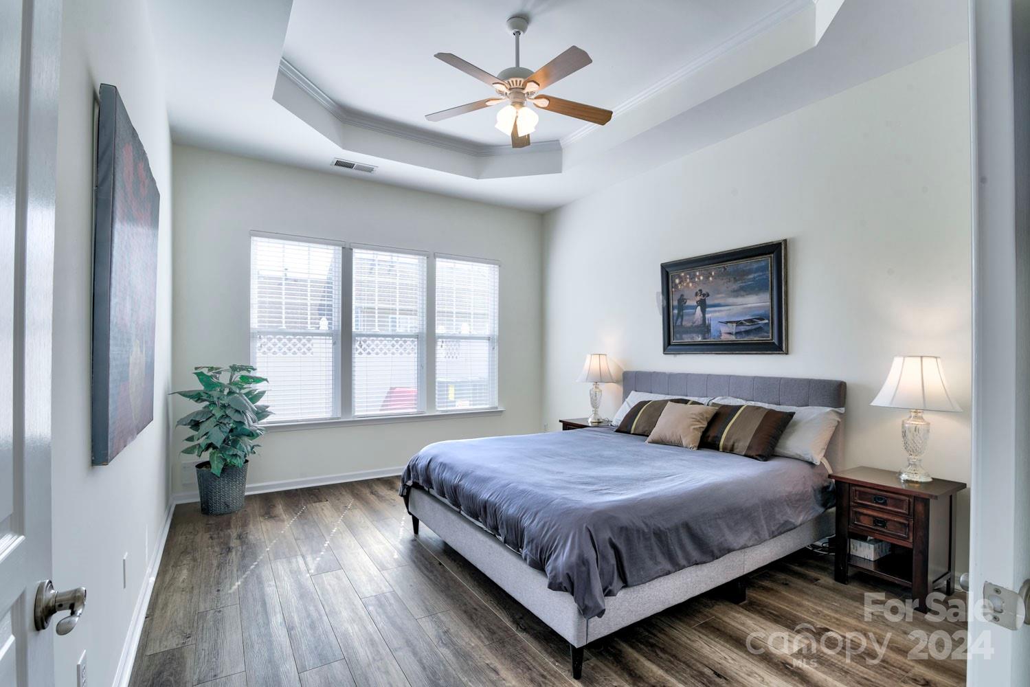 120 Falling Ridge Belmont, NC 28012 - Photo 11 of 18 a bedroom with a large bed chandelier and a window