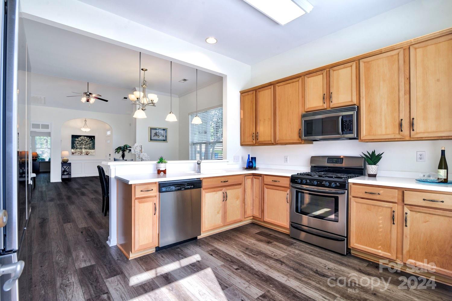 120 Falling Ridge Belmont, NC 28012 - Photo 6 of 18 a large kitchen with stainless steel appliances granite countertop a stove a sink dishwasher and a microwave oven with wooden floor