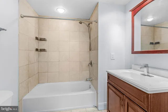 a bathroom with a bathtub a sink a vanity and a shower