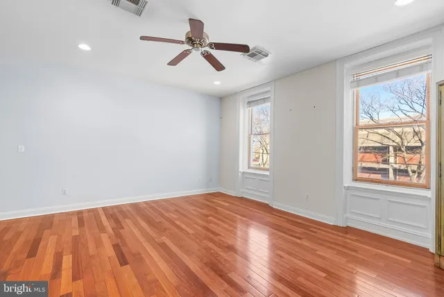 wooden floor in an empty room with a window