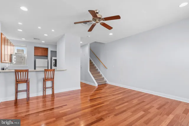 a view of empty room with wooden floor and window
