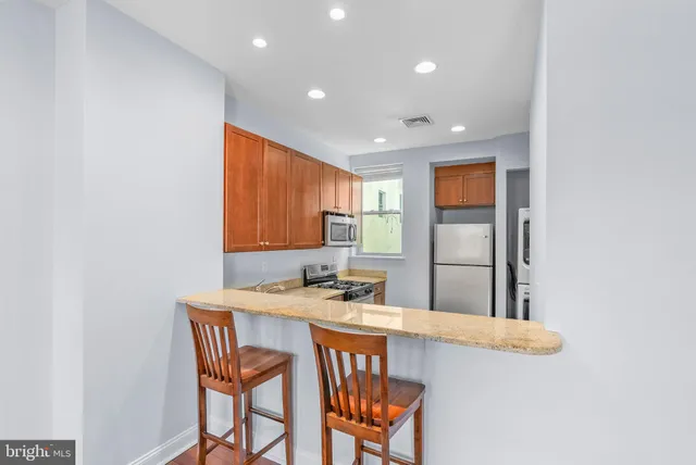 a kitchen with a table and chairs in it