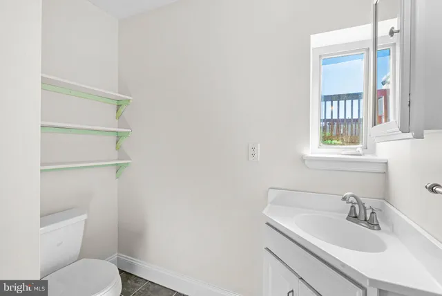 a bathroom with a sink toilet and mirror