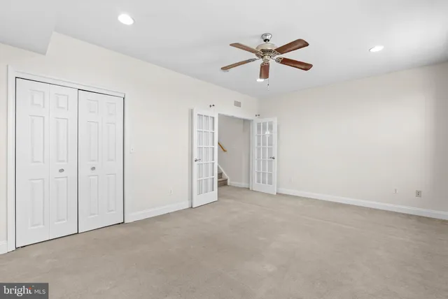 a view of an empty room with a ceiling fan