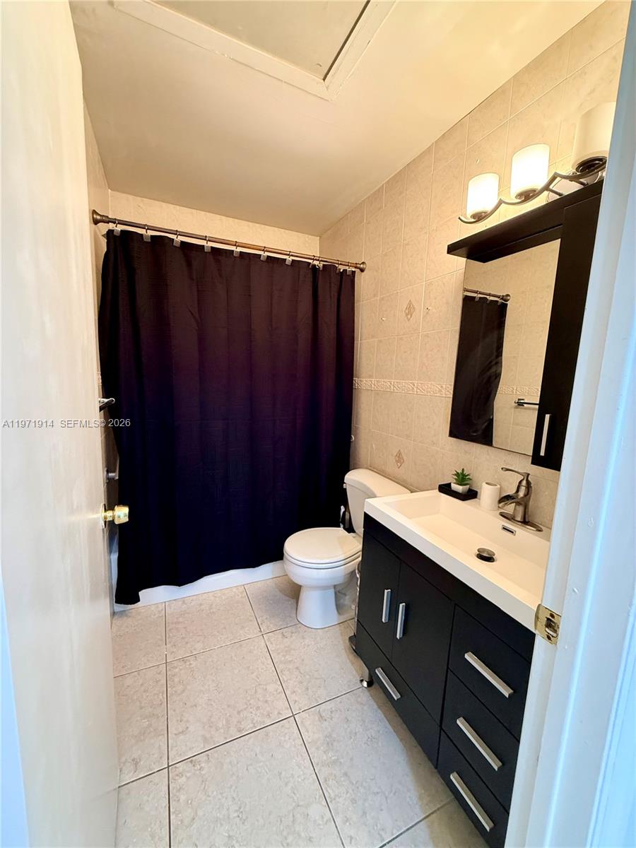 13253 Southwest 96th Terrace Miami, FL 33186 - Photo 15 of 18 a bathroom with a sink vanity toilet and a mirror