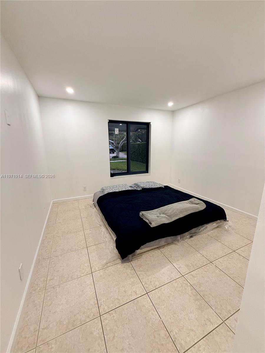 13253 Southwest 96th Terrace Miami, FL 33186 - Photo 16 of 18 a bedroom with a bed and a walk in closet