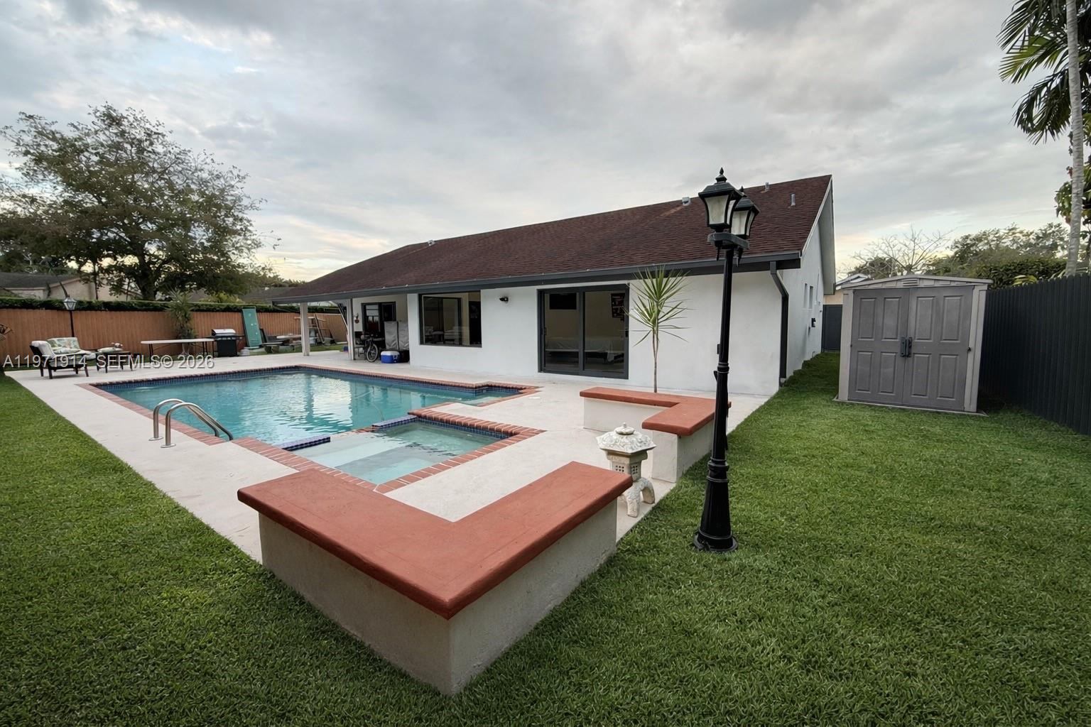 13253 Southwest 96th Terrace Miami, FL 33186 - Photo 7 of 18 a view of a house with a backyard and a patio