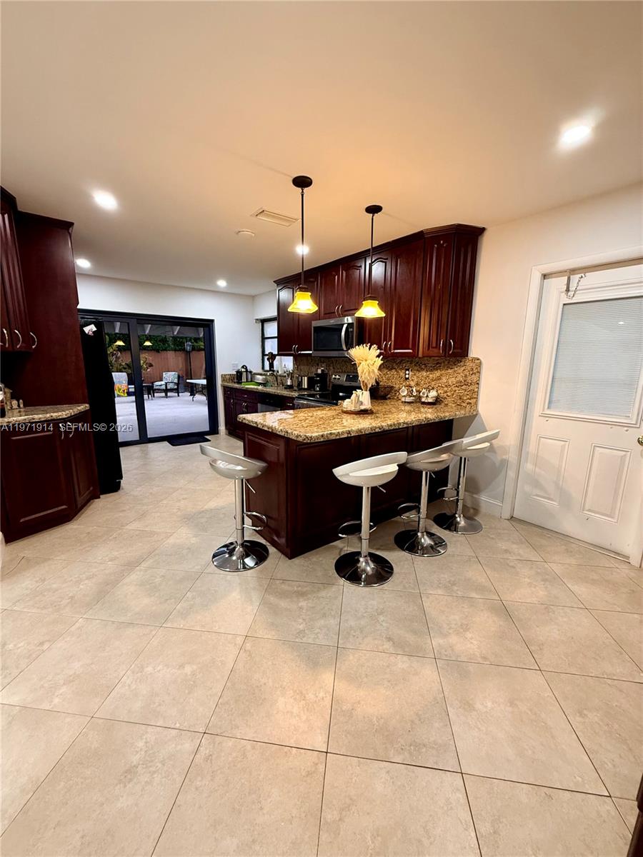 13253 Southwest 96th Terrace Miami, FL 33186 - Photo 10 of 18 a view of a workspace with furniture