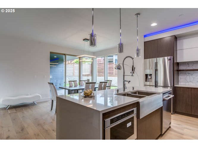 14 Northwest Hood Street Camas, WA 98607 - Photo 15 of 36 a kitchen with stainless steel appliances granite countertop a sink stove and refrigerator