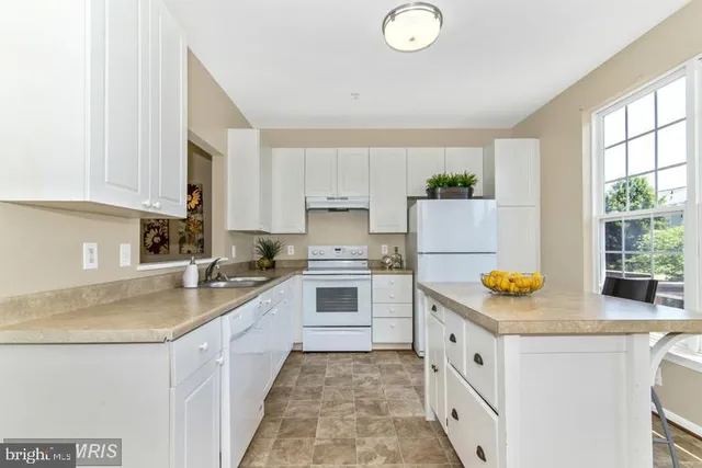 a kitchen with stainless steel appliances granite countertop a sink and cabinets