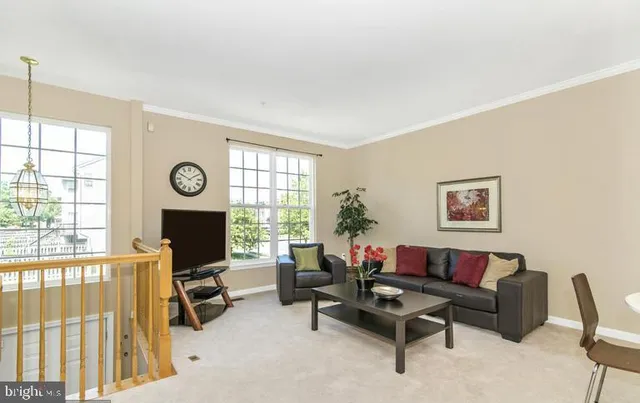 a living room with furniture a flat screen tv and a large window