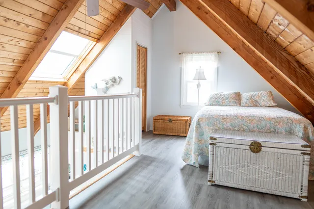 a view of a bedroom with furniture and staircase