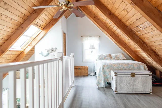 a living room with a bed and a window