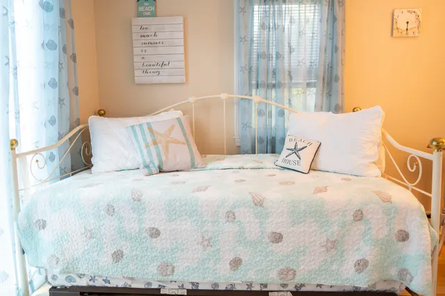 a large bed sitting in a bedroom next to a window