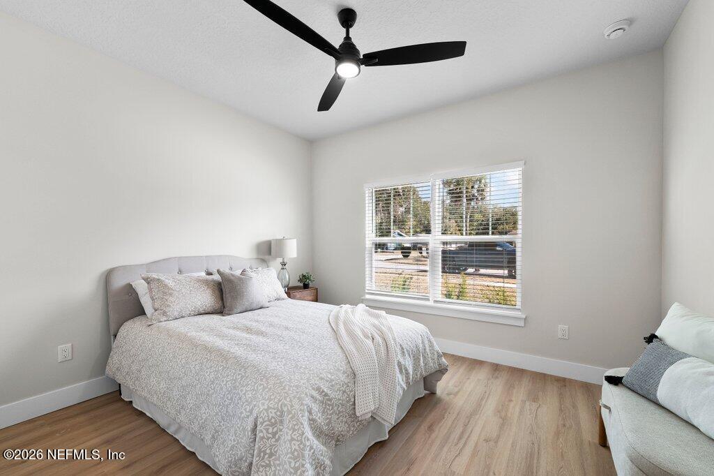 9019 Hipps Road Jacksonville, FL 32222 - Photo 10 of 35 a bed sitting in a bedroom next to a window