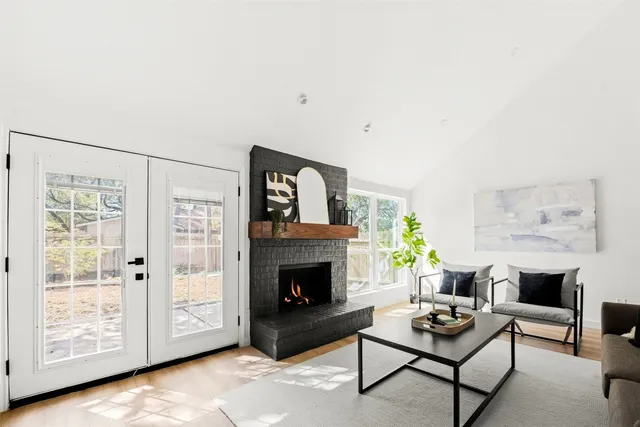 a living room with furniture a rug and a fireplace