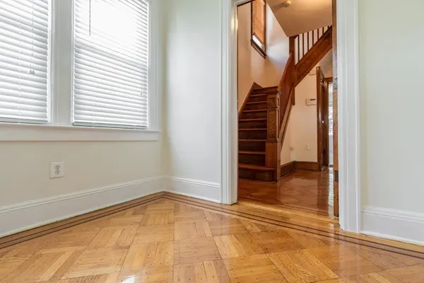 a view of an entryway with wooden floor and door