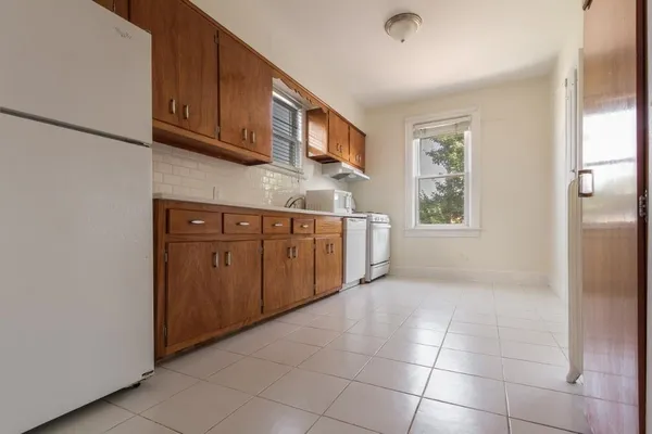a view of a kitchen with furniture and wooden floor