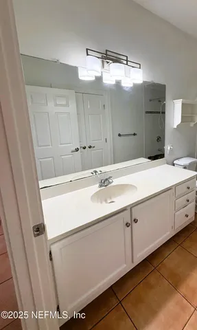 a bathroom with a sink double vanity and a mirror