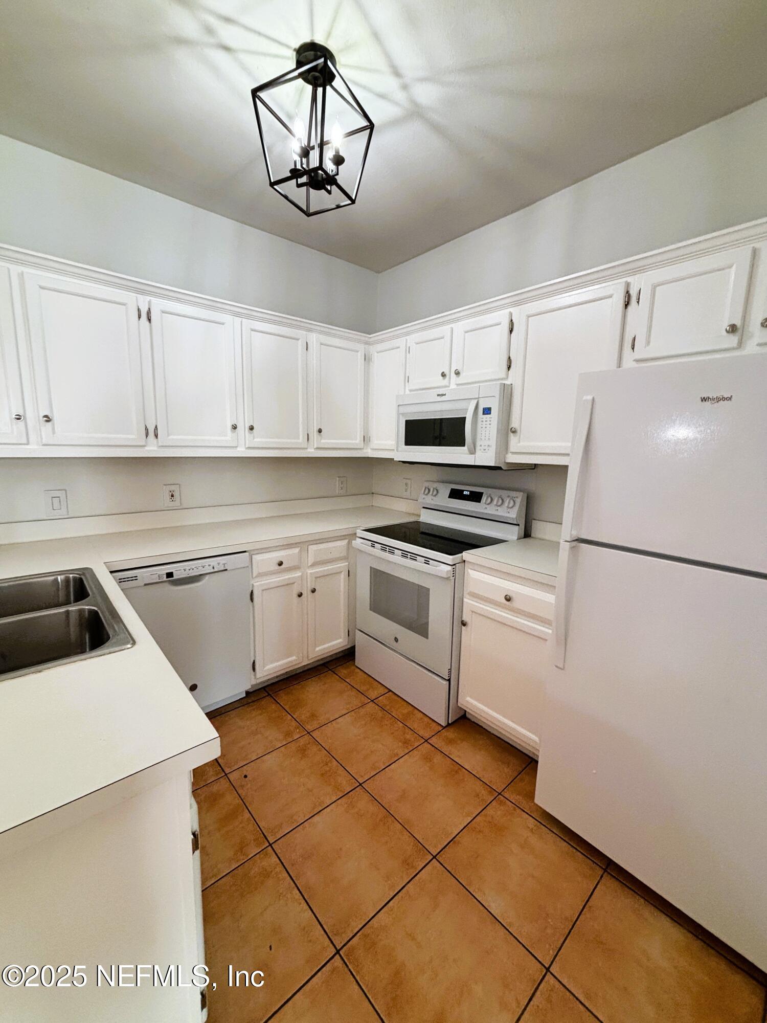 201 Colima Court, Unit 1211 Ponte Vedra Beach, FL 32082 - Photo 4 of 35 a kitchen with cabinets stainless steel appliances and a counter space