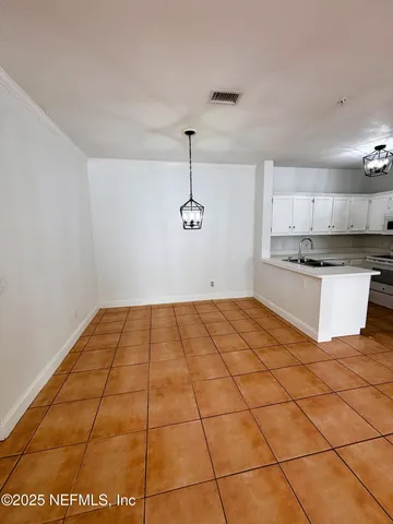 a kitchen with granite countertop a stove a sink and cabinets