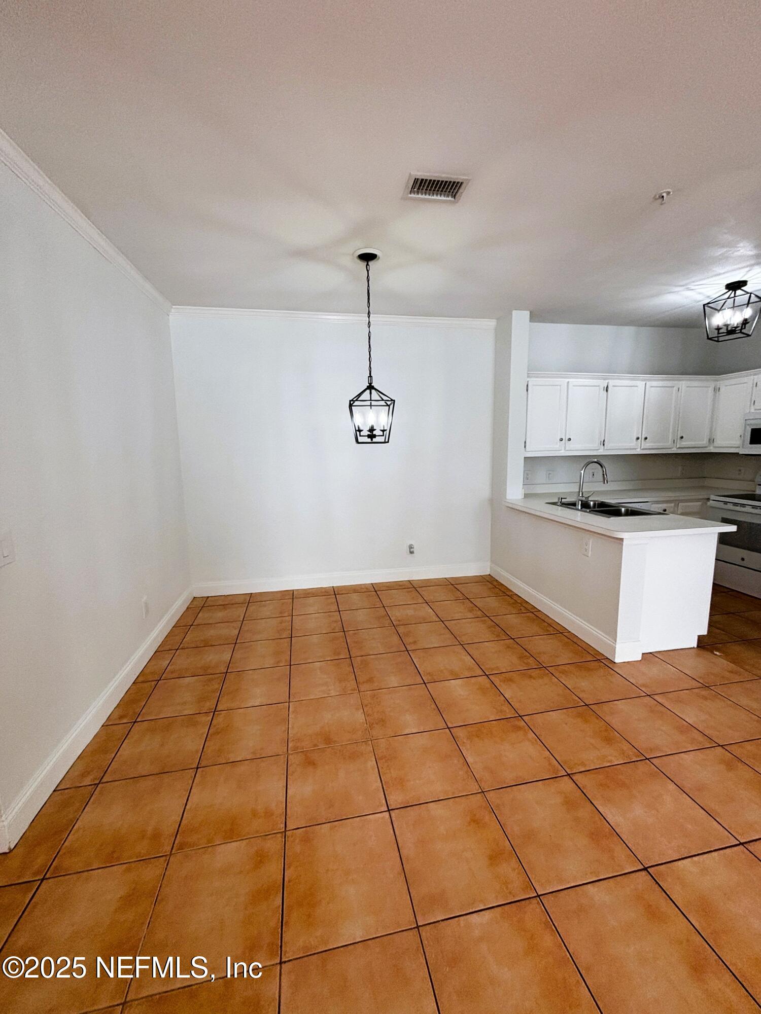 201 Colima Court, Unit 1211 Ponte Vedra Beach, FL 32082 - Photo 6 of 35 a kitchen with granite countertop a stove a sink and cabinets