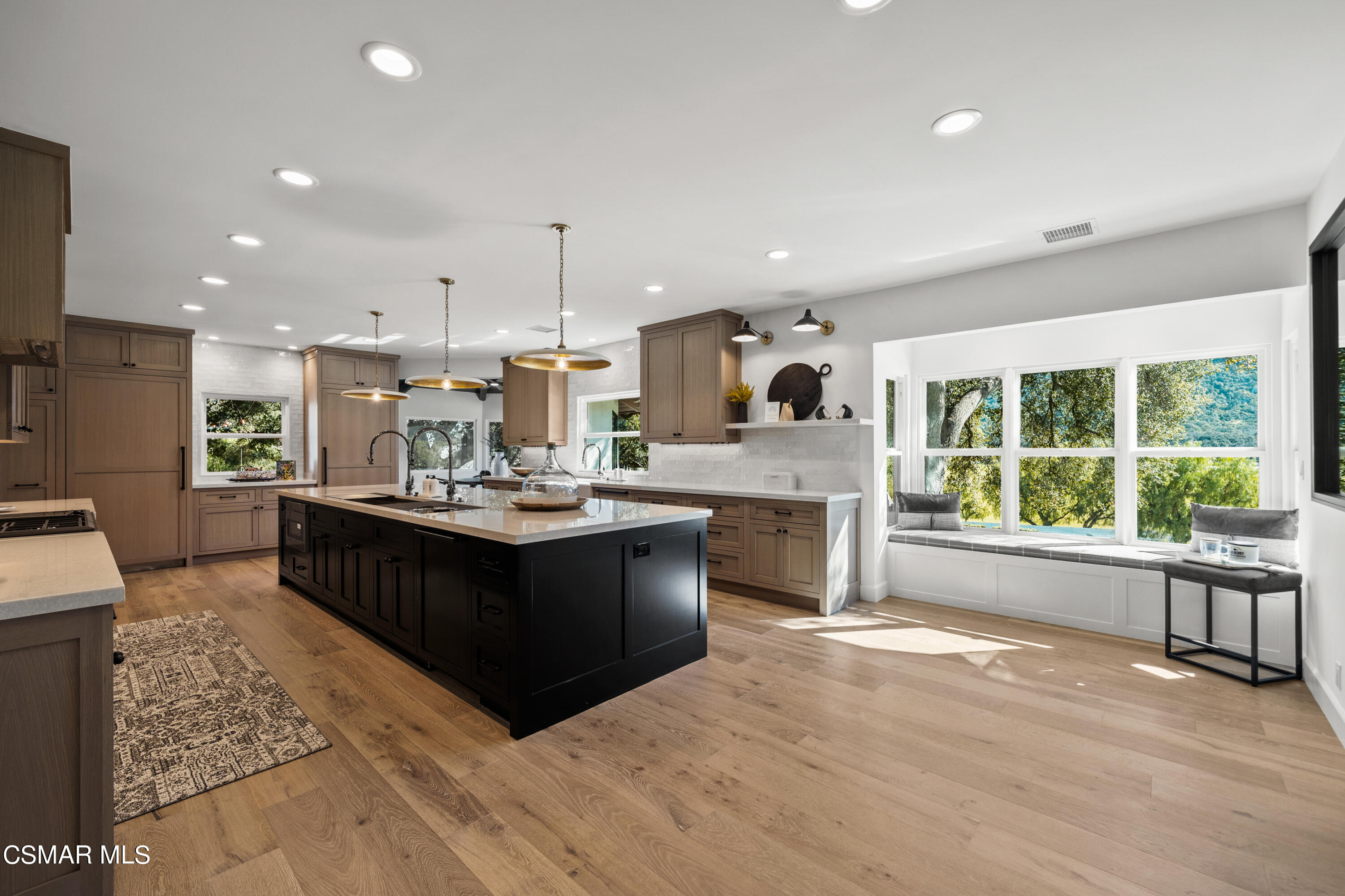 1515 Hidden Valley Road Thousand Oaks, CA 91361 - Photo 23 of 56 a living room with stainless steel appliances kitchen island granite countertop a large counter top space a sink a refrigerator and window