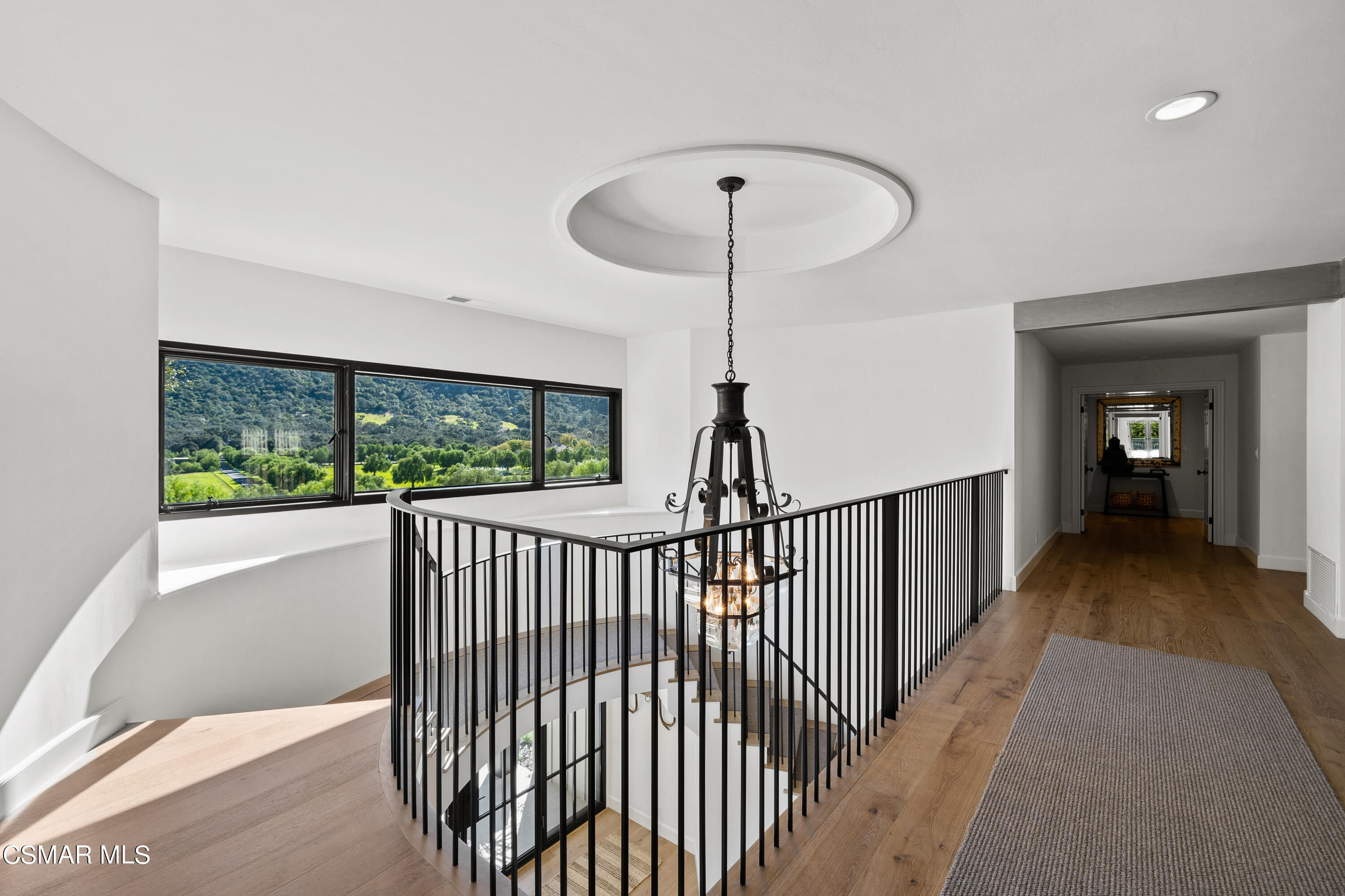 1515 Hidden Valley Road Thousand Oaks, CA 91361 - Photo 33 of 56 a view of a hallway with a chandelier