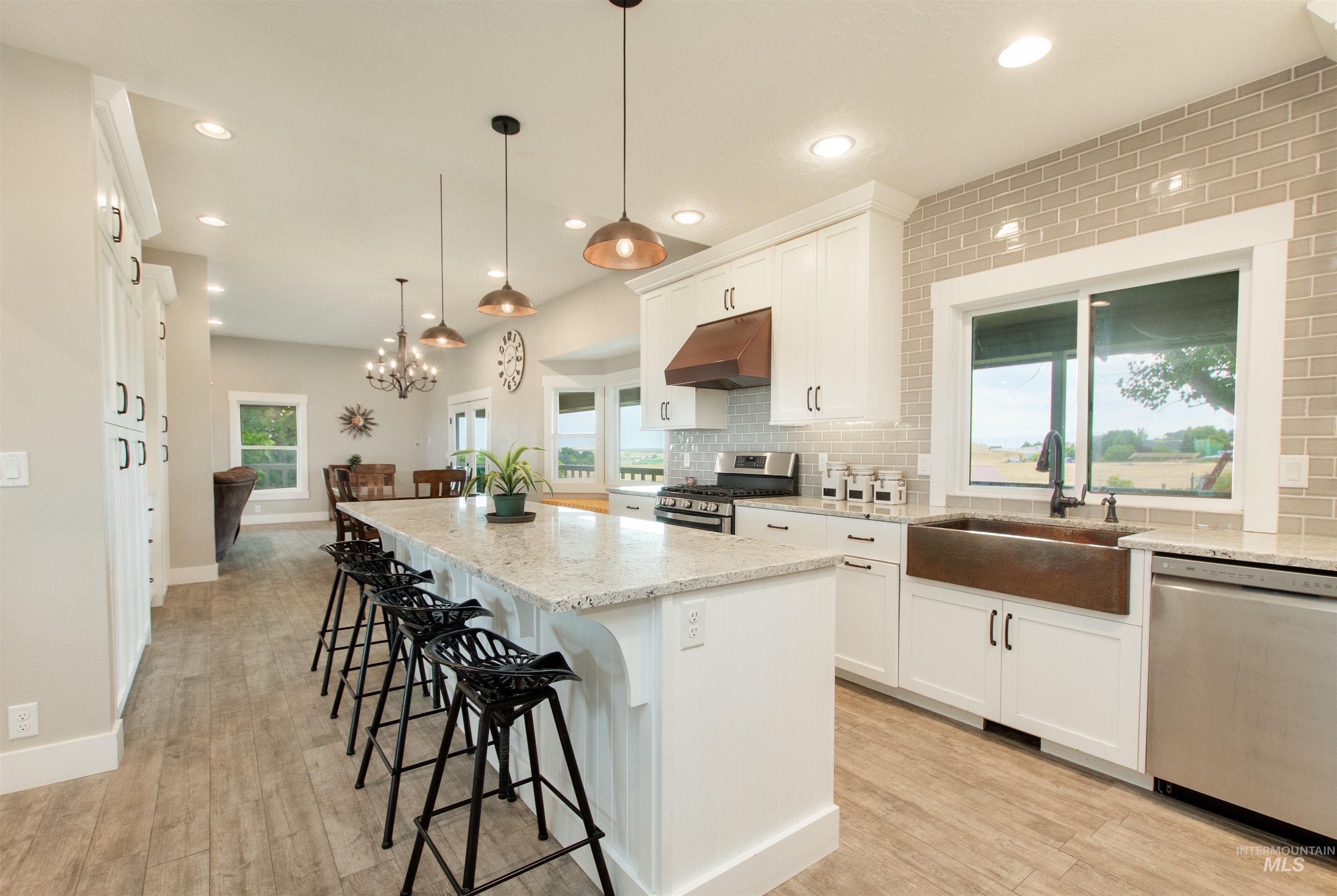 12369 Deer Flat Road Nampa, ID 83686 - Photo 15 of 50 Spacious living area featuring wood-finish flooring, recessed lighting, and an exposed ceiling beam
