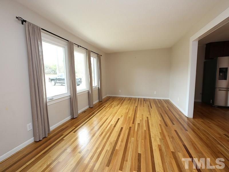 11609 Strickland Road Raleigh, NC 27613 - Photo 2 of 25 Large Living Room, 17.4 x 12.0, with Refinished HARDWOOD Floors '14, NEW Energy Efficient Windows '16, and NEW Paint '14!