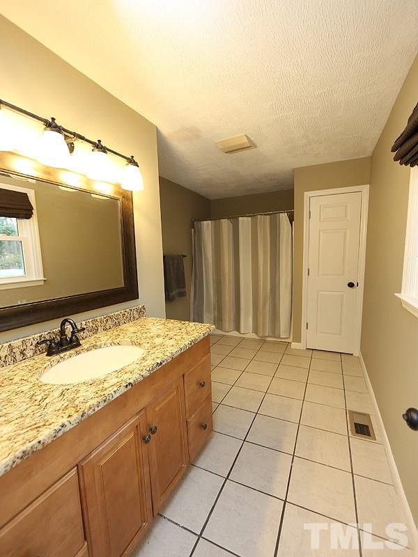 11609 Strickland Road Raleigh, NC 27613 - Photo 8 of 25 Master Bathroom with TILE Floors, GRANITE Counters, Oiled Rubbed Bronze Fixtures, Linen Closet, Tub/Shower Combo, and NEW Energy Efficient Windows '16!