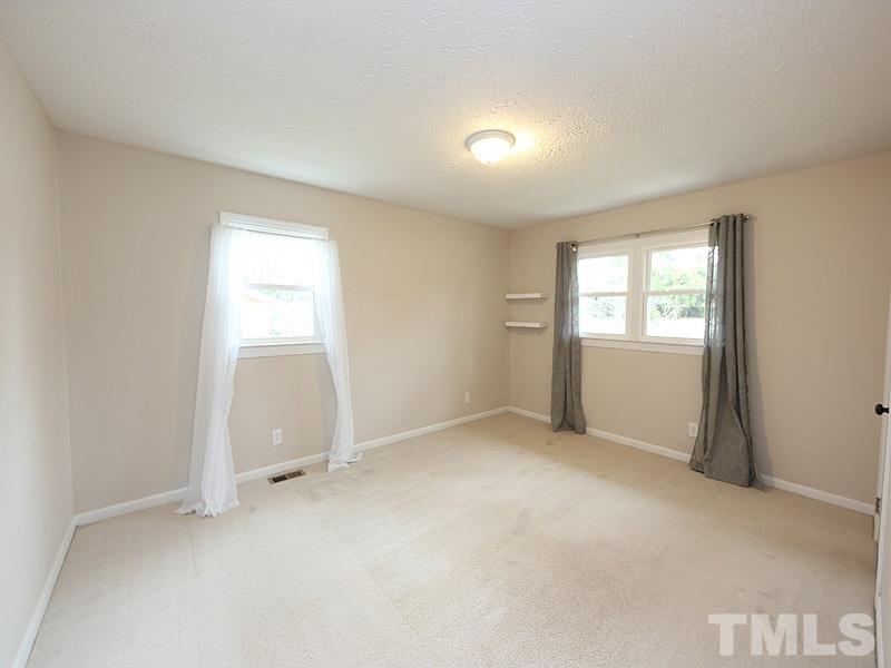 11609 Strickland Road Raleigh, NC 27613 - Photo 10 of 25 Third Bedroom, 12.0 x 10.7, with NEW Energy Efficient Windows '16, NEW Paint '14, Freshly Cleaned Carpet '14, Overhead Light, and Big Closet (There Appear to Be HARDWOOD Floors Underneath the Carpet)