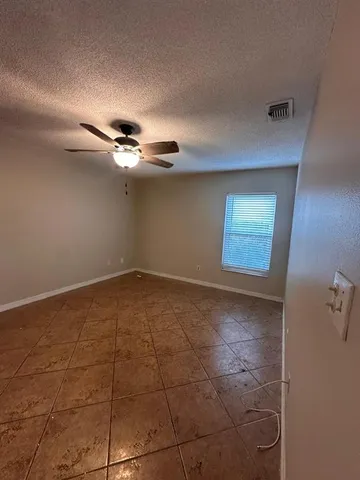 a view of a livingroom with a ceiling fan and window
