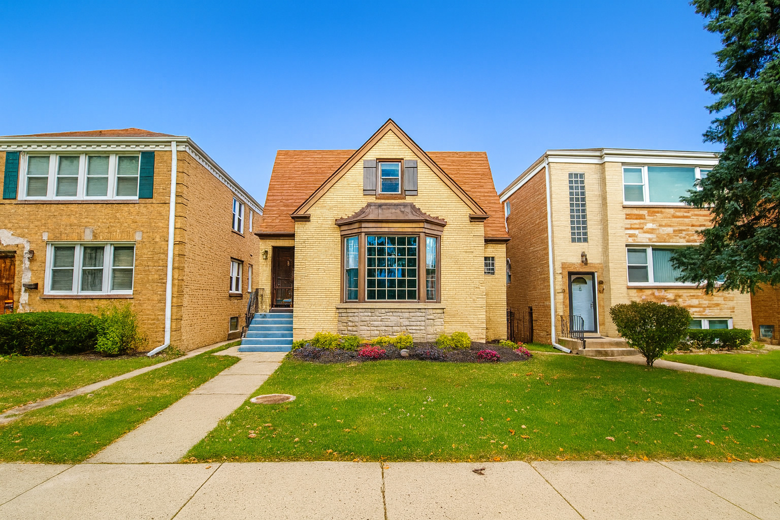 a front view of a house with a yard